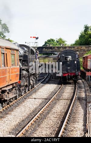Two steam trains pass in Goathland Station, on the North Yorkshire Moors Railway. Stock Photo