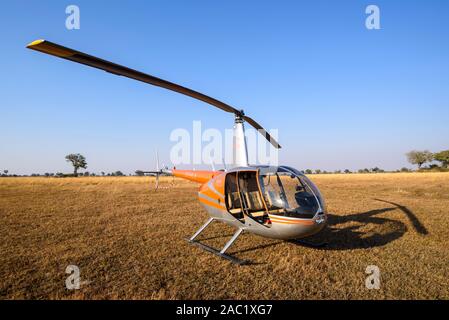 Helicopter ready for a tourist scenic flight, Bushman Plains, Okavanago Delta, Botswana