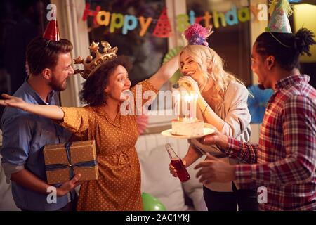 Young happy friends having fun at birthday party and celebration at home Stock Photo