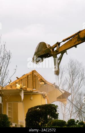Tornado destroyed house is being demolished with an excavator. Stock Photo