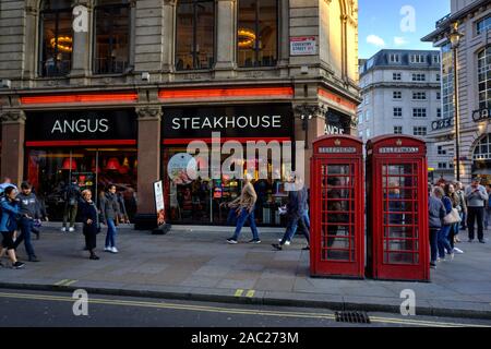 London, United Kingdom - September 7, 2019: Exterior of Angus Steakhouse restaurant in Coventry Street in London UK with motion blurred pedestrians wa Stock Photo