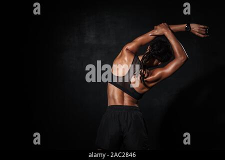 Fitness Woman With Perfect Muscular Body In Black Sportswear Is Standing  With Arms Folded, On White Isolated Background Stock Photo, Picture and  Royalty Free Image. Image 129612999.