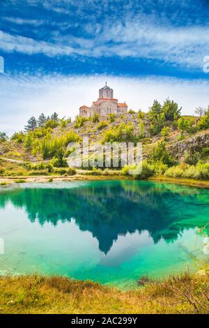 Croatia, Cetina river source water hole and small Orthodox church in Dalmatian Zagora karst landscape Stock Photo
