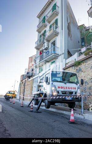 Ortona, Italy - 26 october 2019: truck with basket for work on buildings with workers at work in Ortona Stock Photo