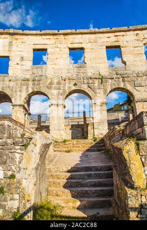 Strong stone arches of monumental ancient Roman arena in Pula, Istria, Croatia. Stock Photo