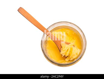 Ghee butter in a glass jar with wooden spoon Stock Photo