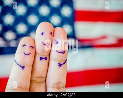 Happy family finger of loving father and mother with son with smiley face on American flag backgroud copy space. Stock Photo