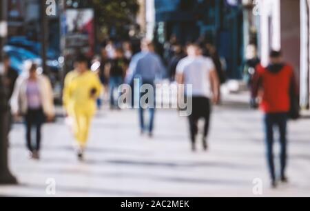 Out of focus background with people crossing street. Stock Photo