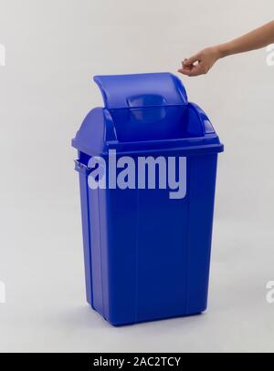 woman hand throwing something into the trash can isolated on white backgound Stock Photo