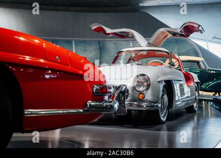 Conception of style. Classic cars standing at black tile indoor on the automobile exhibition Stock Photo