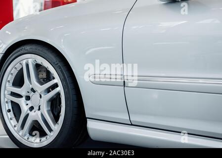 Front part of modern white bright car standing indoors Stock Photo