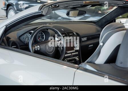 Looking inside modern white polished and stylish car parked indoors Stock Photo