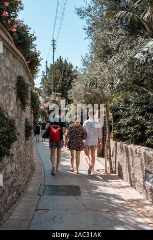 Capri, Italy - August 13, 2019: Tourists with floral clothes walk on the street of Capri Island Stock Photo