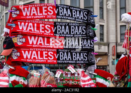 CARDIFF, United Kingdom. 30th Nov, 2019. Half & half scarves and other merchandise for sale on Queens Street ahead of the international rugby match in Cardiff, Wales. © Credit: Matthew Lofthouse/Alamy Live News Stock Photo