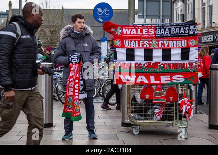 CARDIFF, United Kingdom. 30th Nov, 2019. Half & half scarves and other merchandise for sale on Queens Street ahead of the international rugby match in Cardiff, Wales. © Credit: Matthew Lofthouse/Alamy Live News Stock Photo