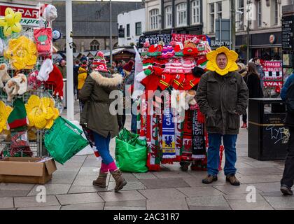 CARDIFF, United Kingdom. 30th Nov, 2019. Half & half scarves and other merchandise for sale on Queens Street ahead of the international rugby match in Cardiff, Wales. © Credit: Matthew Lofthouse/Alamy Live News Stock Photo