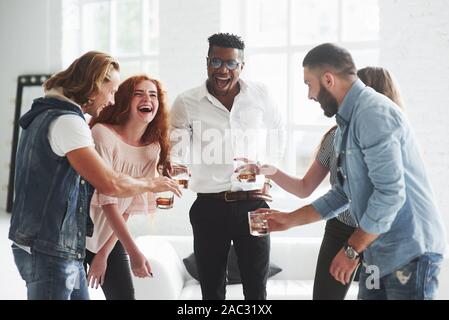 Five multiracial office workers celebrate their success in business Stock Photo
