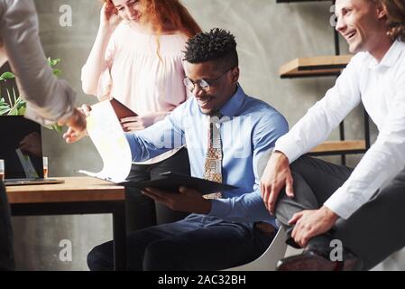 Work with documents and reports. Office workers having conversation during their job Stock Photo