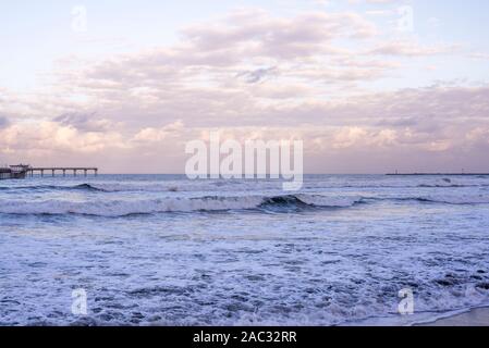 Coastal sunrise on an autumn morning. The Ocean Beach Pier on the horizon. San Diego, California, USA Stock Photo