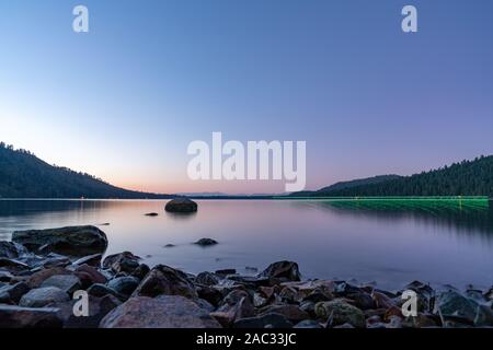 A Woman Fishing During Sunset in Lake Tahoe, Nevada Stock Photo