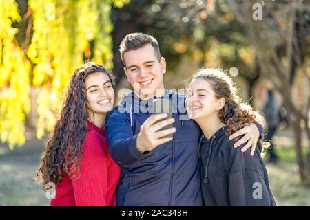 Three students taking a selfie on  campus Stock Photo