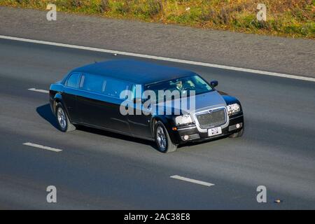 2009 Chrysler stretched large luxury vehicle; UK Vehicular traffic, transport, modern vehicles, saloon cars, vehicles, vehicle, uk roads, motors, motoring south-bound on the 3 lane M61 motorway highway Stock Photo