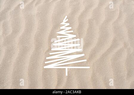 White fir tree on a beach of sand Stock Photo