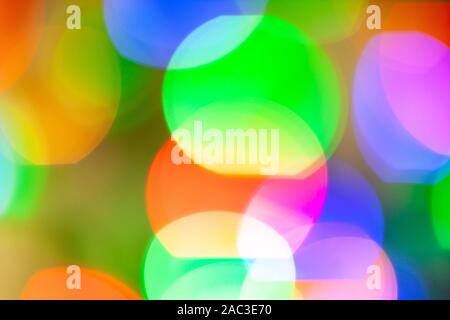 Large yellow, red, green, purple, violet and blue bokeh balls on bright background. Stock Photo