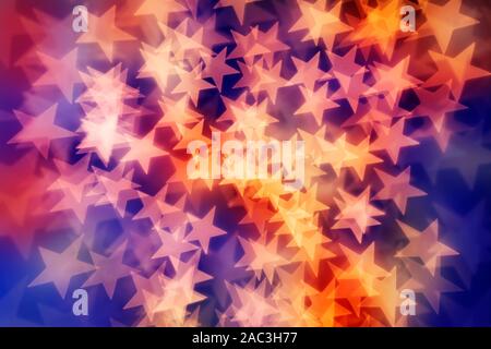 Star shaped bokeh background in yellow, reds and purple tones. Stock Photo