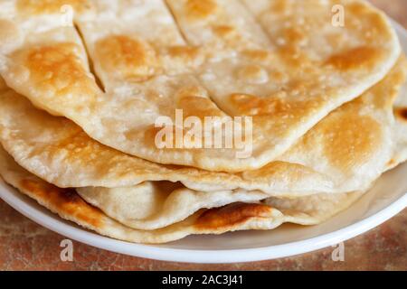 Russian fried home water-bisquits on white table. Selective focus. Macro. National cuisine. Stock Photo