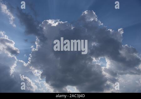 Cumulus clouds lit by the sun Stock Photo