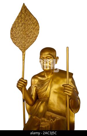 Golden Buddhist monk with a staff and a fan isolated on a white background. Buddhist old man in Thai style. Stock Photo