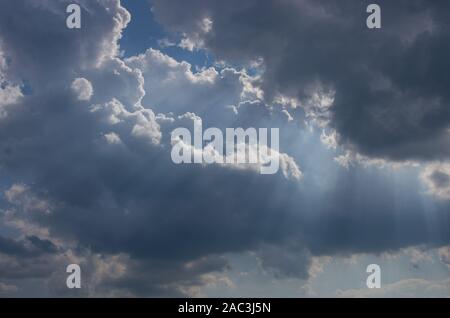 Cumulus clouds lit by the sun Stock Photo