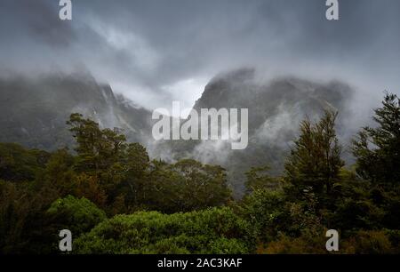 Typical heavy rain and heavy cloud over MiIlford Road the only road access to Milford Sound Fjordland New Zealand one of the wettest places on earth Stock Photo