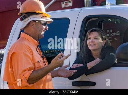 A construction worker talks with a woman in a truck, Sept. 20, 2016, in Huntingdon, Tennessee. Stock Photo