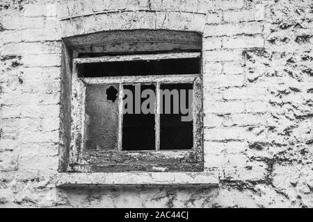 Derelict brick barn with a smashed window Stock Photo
