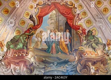 COMO, ITALY - MAY 8, 2015: The fresco of Visitation fresco in church Santuario del Santissimo Crocifisso by Gersam Turri (1927-1929). Stock Photo