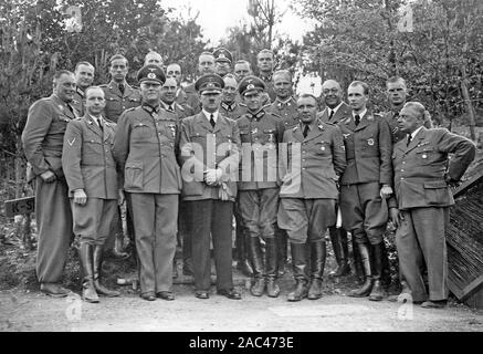ADOLF HITLER (1889-1945) at his field HQ in May/June 1940 surrounded by staff. At far right is his official photographer Heinrich Hoffmann. Stock Photo