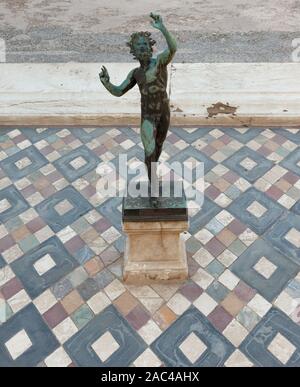 Dancing faun statue in the house of the faun of Pompeii (Pompei). Ancient Roman city in Pompei, Province of Naples, Campania, Italy Stock Photo