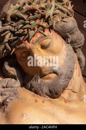 BANSKA STIAVNICA, SLOVAKIA - FEBRUARY 19, 2015: The detail of carved statue of Christ on the cross as the part of baroque Calvary from years. Stock Photo