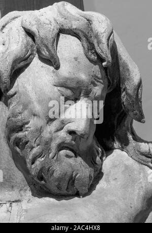 BANSKA STIAVNICA, SLOVAKIA - FEBRUARY 19, 2015: The face detail of carved statue of Impenitent thief as the part of baroque Calvary. Stock Photo