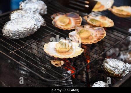 Grilled scallops with herbs and hot potatoes Stock Photo