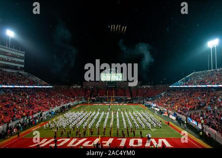 Raleigh, North Carolina, USA. 30th Nov, 2019. Nov. 30, 2019 - Raleigh, North Carolina, USA - The NC State band, 'The Most Dangerous Band in the South, ' plays the National Anthem as a aerial demonstration team flies over Carter-Finley Stadium before Saturday's game between the NC State Wolfpack and University of North Carolina Tar Heels. The Tar Heels defeated the Wolfpack, 41-10. Credit: Timothy L. Hale/ZUMA Wire/Alamy Live News Stock Photo