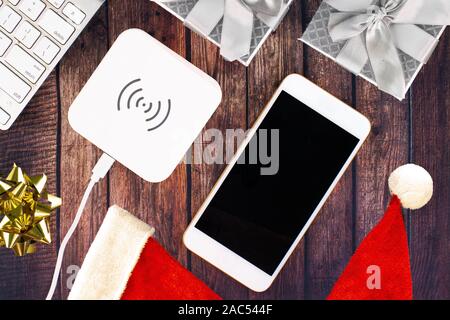 Electronics with Christmas holidays ornaments around Stock Photo