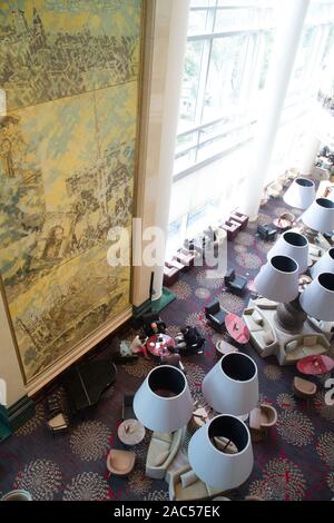 Top down view of sitting area with arm chairs, colourful carpet and a painting on the wall Stock Photo