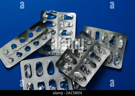 Blank packaging with medicines on blue background. Treatment of diseases. no hope. hopelessness. Stock Photo