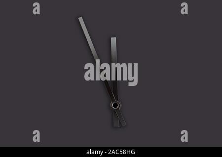 black pointers of a clock isolated on black background Stock Photo