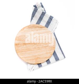 Empty wooden platter with blue napkin isolated on white background, top view, copy space. Wooden cutting board for pizza, design element. Stock Photo