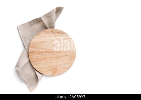 Empty wooden platter with linen napkin isolated on white background, top view, copy space. Wooden cutting board for pizza, design element. Stock Photo