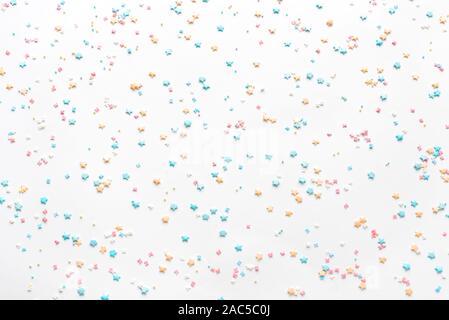 Festive border frame of colorful pastel sprinkles on pink background, copy  space top. Sugar sprinkle dots and stars, decoration for cake and bakery.  Top view or flat lay Stock Photo - Alamy